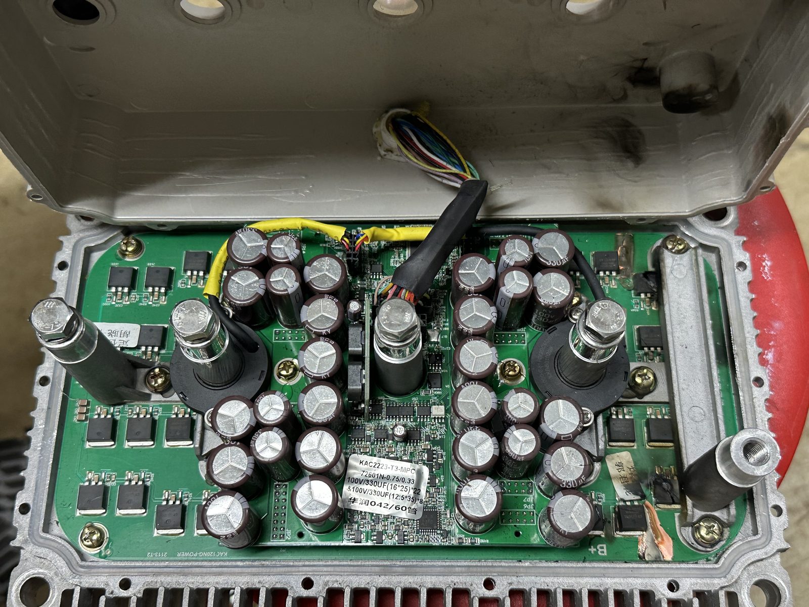 Kelly KLS8080N motor controller opened up, showing scorch marks on the housing and PCB after reverse polarity damage